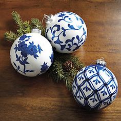 three blue and white ornaments on a wooden table