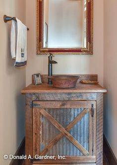 a bathroom with a sink, mirror and towel rack