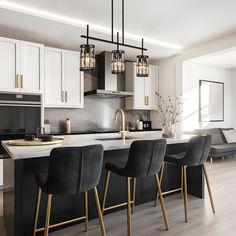 a kitchen with white cabinets and black bar stools next to an island in the middle