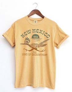 Thanks for checking out the New Mexico BOHO road runnner Shirt. This 'Land of Enchantment' graphic has a Bohemian aesthetic with vintage typography and style. Throw this shirt on with a trip to Santa Fe on your mind. For the Comfort Colors 1717, The soft-washed, garment-dyed fabric has a weathered vintage look that hold up well, but soften over over time for a warm look. This fully customized tee is made 100% with ring-spun cotton. The double-needle stitching throughout the tee makes it highly d Souvenir T Shirt, Mexico Boho, Mexico Shirts, Comfort Colors Tshirt, Land Of Enchantment, Road Runner, Custom Tees, Spring 2024, Funny Tees