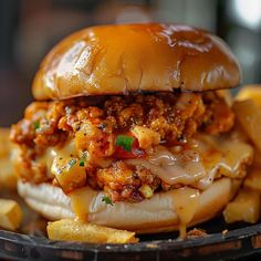 a close up of a sandwich on a plate with french fries