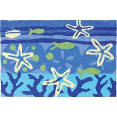 a blue rug with starfishs and seaweed on it