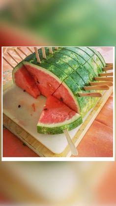 a large piece of watermelon sitting on top of a cutting board