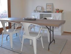 a dining room table with two chairs and a bowl on it