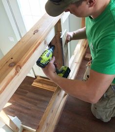 a man in a green shirt is using a drill