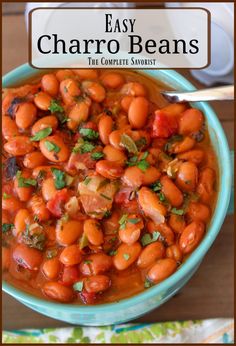 a blue bowl filled with beans on top of a wooden table