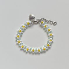 "Handmade Beaded Bracelet ✿ Made with glass seed beads and metal accents ✿ Milky white, yellow, and light seafoam green ✿ The bracelet has 1.5\" of extension chain" Handmade White Crystal Bracelet With Flower Shape, Handmade White Crystal Bracelet In Flower Shape, Handmade White Crystal Flower Bracelet, White Round Beaded Friendship Bracelets For Spring, Handmade White Crystal Bracelet For Friendship, White Spring Jewelry For Friendship, Yellow Beaded Chain Bracelets, Handmade White Beaded Bracelets For Spring, Yellow Beaded Chain Bracelet