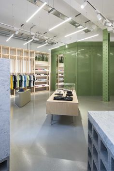 the inside of a clothing store with lots of shelves