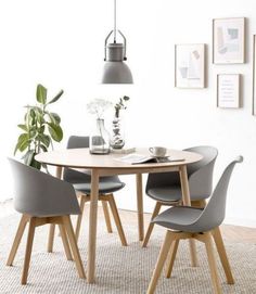 a dining table with four chairs around it