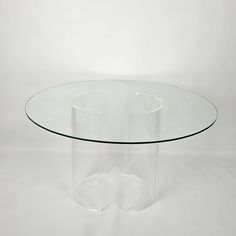 a clear glass table sitting on top of a white floor