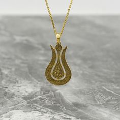 Crafted with intricate detail and spiritual significance, the Ayatul Kursi Tulip Necklace is more than just a piece of jewelry - it's a heartfelt token of faith and love. This exquisite necklace combines the elegance of 925 sterling silver with the luxurious touch of 18K Gold Plating, creating a stunning accessory that symbolizes strength and devotion. Adorned with Islamic calligraphy, including the revered Ayatul Kursi, this necklace is a meaningful gift for Muslim women, moms, or anyone looking to embrace their faith with style. Perfect for birthdays, anniversaries, or any special occasion, this necklace is a beautiful reminder of the power of faith and love. Give the gift of divine elegance with the Ayatul Kursi Tulip Necklace and let its beauty illuminate the heart of the recipient. Si Spiritual Filigree Flower Pendant Necklace, Traditional Teardrop Necklace For Gift, Spiritual Medallion Necklace With Filigree Details, Spiritual Medallion Necklace With Filigree, Spiritual Filigree Medallion Necklace, Spiritual Medallion Filigree Necklace, Traditional Teardrop Pendant Jewelry Gift, Traditional Engraved Flower Pendant Necklace, Traditional Brass Necklace For Gift