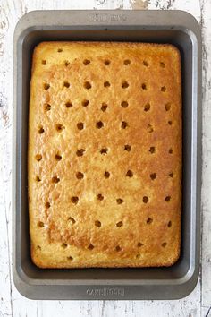 a cake in a pan sitting on top of a wooden table