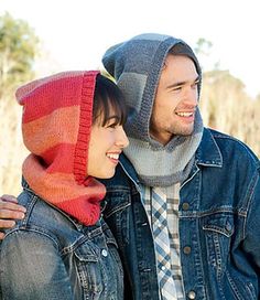 a young man and woman are smiling while wearing knitted scarves on their heads