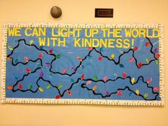 a bulletin board that says we can light up the world with kindness