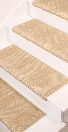 the stair treads are made from white wood and woven with natural jute fabric