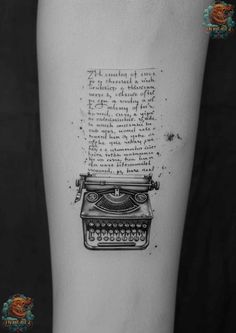 a tattoo with an old typewriter on the side of the arm and writing on it