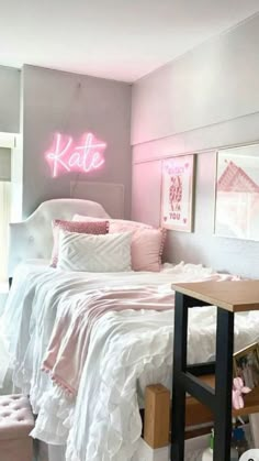 a bed room with a neatly made bed and a neon sign on the wall