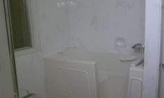 a bathroom with a white bath tub next to a walk in shower and a toilet