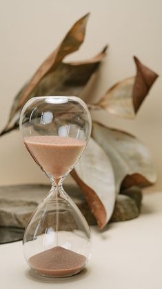 an hourglass sitting on top of a white table