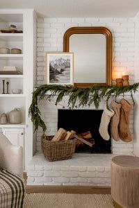 a living room with a fire place and christmas decorations