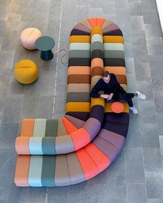 a person sitting on a multi colored couch