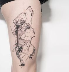 a woman's leg with a tattoo on it that has lines and shapes in the shape of a wolf