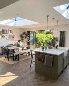 an open kitchen and dining room with skylights