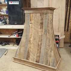 a wooden stove top sitting in the middle of a room