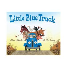 the little blue truck is driving down the road with animals on it's back