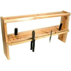 a wooden shelf with tools hanging from it