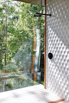 a bathroom with a shower head and glass walls