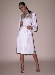 Our best selling Angel Sleeve Robe, now in midi length. Cut from luxe silk charmeuse, with a playful fit and wide sleeves. Wraps across the body and is secured by a sash. Pair with the Frankie Lace Boned Balconette Bra and Thong for an immaculate set.  92% Silk & 8% SpandexDry clean only Model is 5'10 and wearing a size XS/S. Bra And Thong, Angel Sleeve, Silk Robe, Balconette Bra, Silk Charmeuse, Wide Sleeves, Midi Length, Angel, Silk