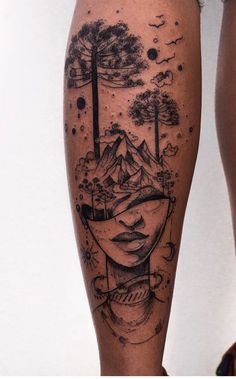 a woman's leg with an artistic tattoo on it