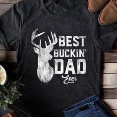 Best Buckin' Dad Ever T-Shirt,Funny Mens Papa Grandpa Hunting Gift Shirt - Vintage Deer Hunter Dad TShirt for Father's Day, Hunting Dad Gift ABOUT OUR PRODUCTS: The personalized Standard T-Shirt is the perfect canvas for self-expression and individual style. Crafted from 100% preshrunk cotton, this classic short-sleeve tee not only offers comfort but also provides a unique opportunity for print on demand customization. Whether you're looking to showcase your creativity, promote your brand, or co Black T-shirt With Lettering For Father's Day, Father's Day Graphic Tee With Lettering, Funny Letter Print T-shirt For Father's Day, Father's Day T-shirt With Lettering And Short Sleeves, Father's Day T-shirt With Lettering, Funny Short Sleeve T-shirt With Lettering, Dad Tshirt, Deer Hunter, Deer Hunters