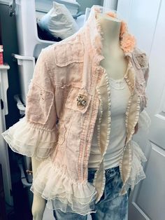 a mannequin wearing a pink jacket with ruffles