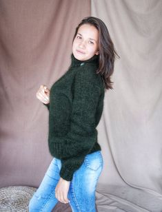 Dark green fluffy cardigan Knit angora sweater  Cropped sweater color bottle Fluffy vest pulover with high collar Handmade women chunky sweater Size S-MREADY TO SHIP!Stylish, fashionable, Dark green knitted sweater  color bottle is made from soft yarn. Yarn constitution  angora and nylon.This lovely  angora sweater will be a great addition to your look. The high collar will keep your neck warm.Cable Knit Sweater will be a pleasant gift for yourself and your loved ones.The sweater can be worn wit Winter Mohair Turtleneck Sweater, Green Funnel Neck Sweater For Winter, Green Mohair Knitted Sweater, Green Funnel Neck Winter Sweater, Green Mohair Cozy Sweater, Cozy Green Mohair Sweater, Green Mohair Winter Sweater, Fluffy Vest, Fluffy Cardigan