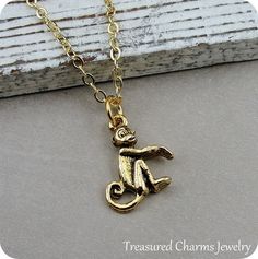 This Tiny Monkey Charm necklace comes on a gold plated chain that is available in different lengths. Please choose your desired length from the drop-down menu when placing the item in your shopping cart. { CHARM DETAILS }★ Material: Pewter ★ Finish Color: Gold★ Measurements: 1/2" x 5/8"★ Dimensions: Two-sided★ Made in the USA{ KEEP SHOPPING } More monkey themed items available from my shop: https://www.etsy.com/shop/treasuredcharms/search?search_query=monkey{ PACKAGING }Packaging varies but item Gold Novelty Charm Necklaces For Gifts, Gold Novelty Charm Necklace For Gifts, Novelty Gold Jewelry Gift, Novelty Gold Pendant Jewelry, Novelty Gold Metal Jewelry, Handmade Gold Novelty Jewelry, Adjustable Gold Chain Charm Necklace For Gift, Safari Necklace, Monkey Necklace