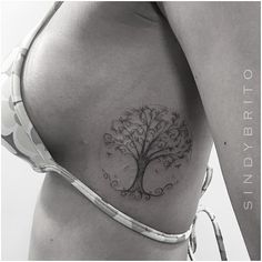 a woman with a tree tattoo on her stomach