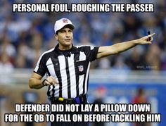 a referee pointing at the ball during a football game with an ad on it that says, personal foul, roughing the passer defender did not pay a blow down for the