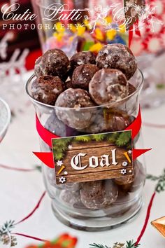 a bowl filled with chocolate covered donuts on top of a table