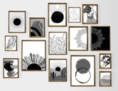 an assortment of black and white art hanging on a wall with wooden frames in front of them