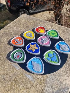 a group of badges sitting on top of a cement slab