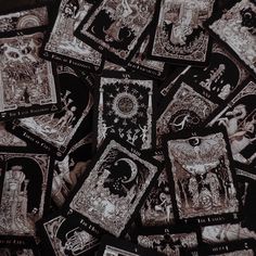 black and white photograph of tarot cards scattered on top of each other in rows