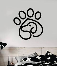 a bedroom with a dog paw wall decal