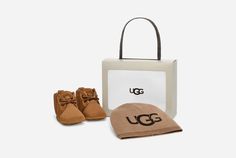 It's:  inchIsn't that the cutest thing you've ever seen?! inch in a gift bag. The Baby Neumel and UGG® Beanie gift set wraps up everything you need to show your love for those expectant parents who just invited you to their shower or for your own little one at home.This suede bootie and knit logo beanie make the perfect pair. Bonus kid tip: Match with mom or dad in the Neumel in adult sizing. | Baby Beanie. Blended Polyester and Nylon knit hat with printed UGG® logo. Baby Neumel Bootie. Suede up Ugg Store, Ugg Neumel, Baby Uggs, Knit Logo, Kid Clothes, Cycling Fashion, Baby Boots, Classic Boots, Elastic Laces