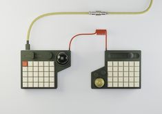 two electronic devices connected to each other on a white surface