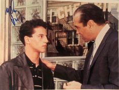 an autographed photograph of two men in suits and ties, one is touching the other's hand