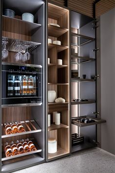 an open refrigerator filled with lots of donuts and wine glasses on top of shelves