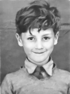 black and white photograph of a young boy wearing a shirt and tie with his hair pulled back