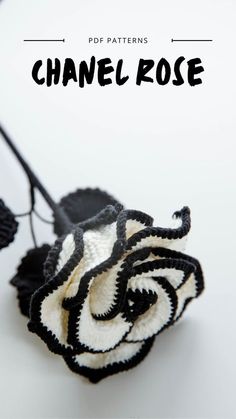 a crocheted flower with black and white petals